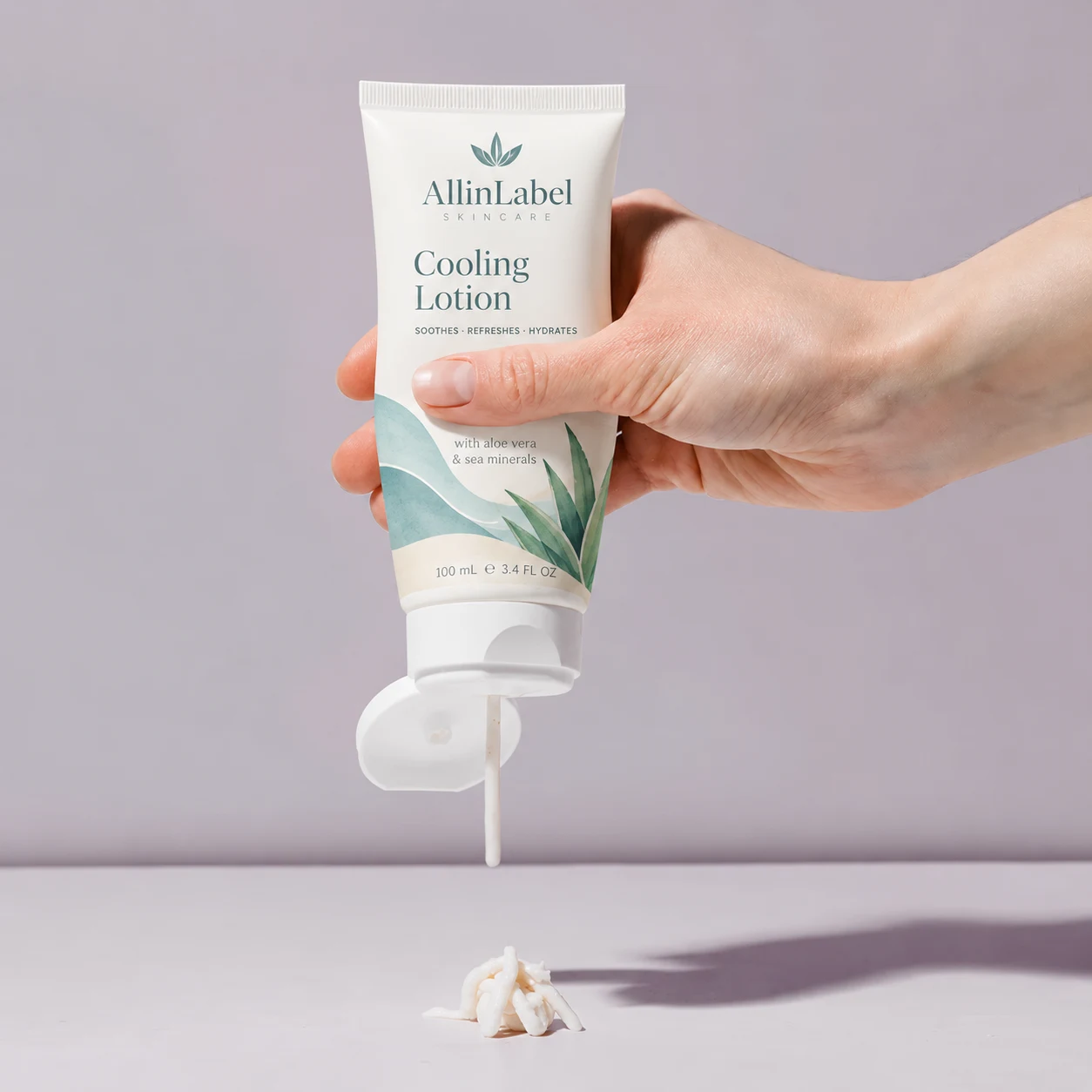 Hand squeezing a skincare tube to dispense lotion, showing how a conformable PE film label follows the tube deformation